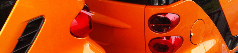 Gloss orange paintwork on the rear of a car