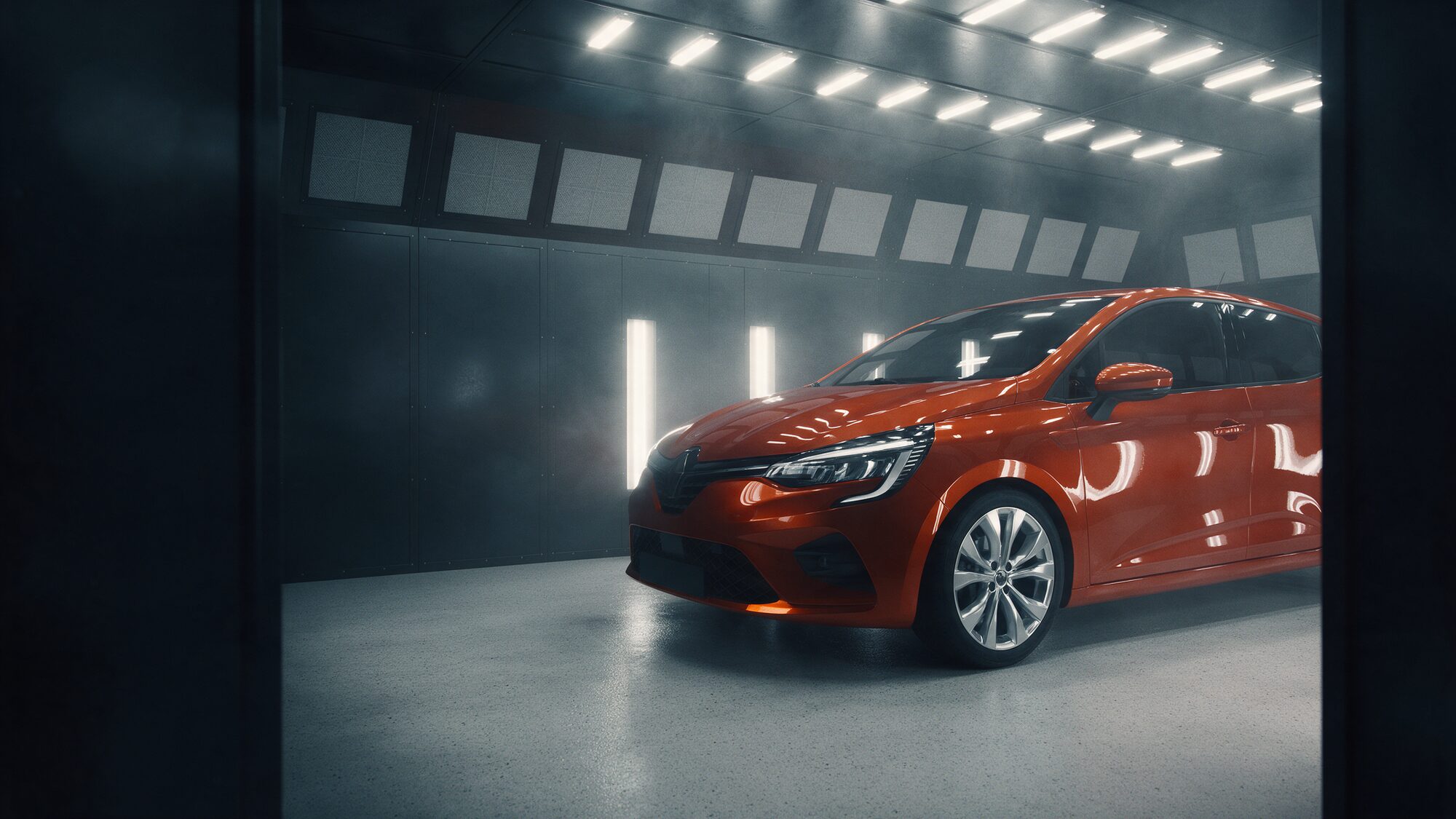 Freshly painted orange car under spray booth lights